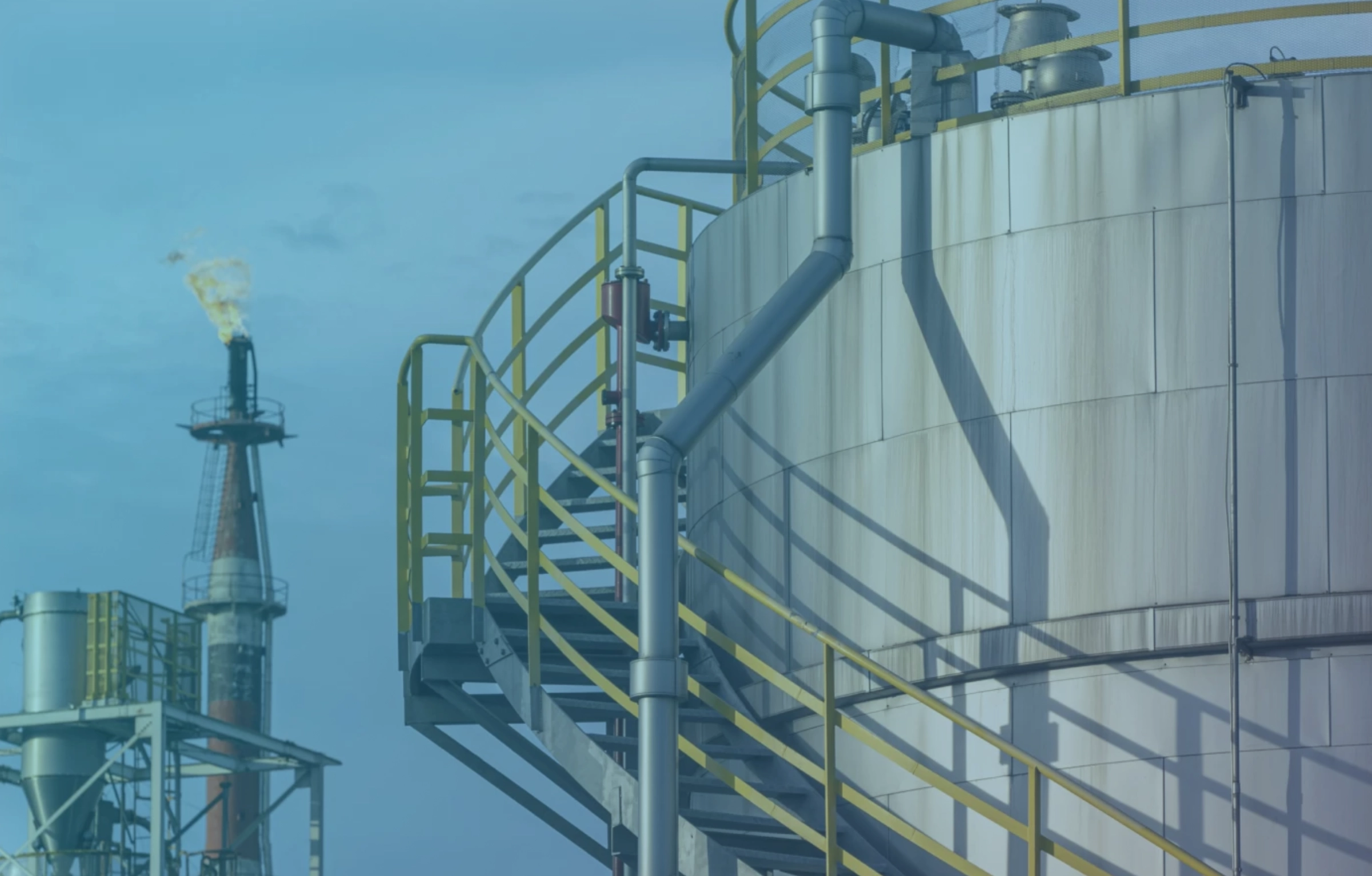 Oil refinery flare stack and storage tank — energy and utility infrastructure monitored with S2RE